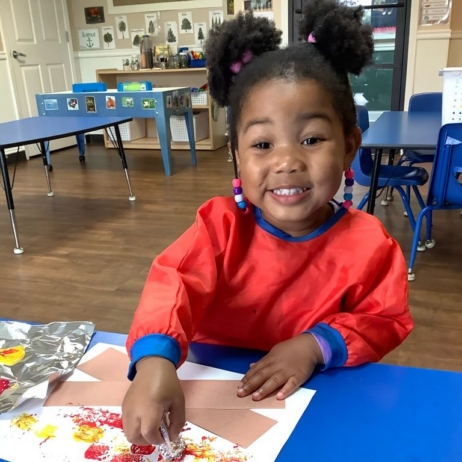 a child doing crafts indoors