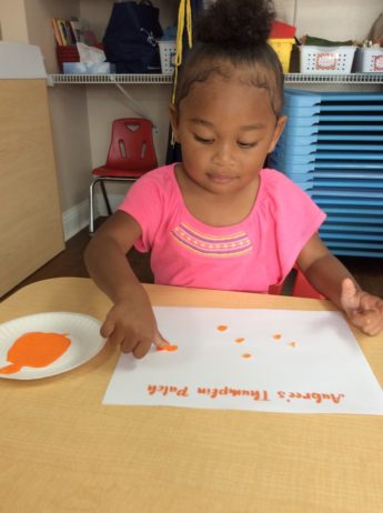 a child doing crafts indoors