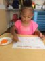 a child doing crafts indoors