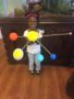 A child holding a model of the solar system