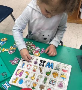 a child playing a letter association game