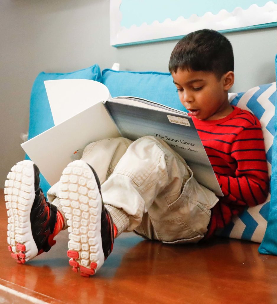 a child reading indoors