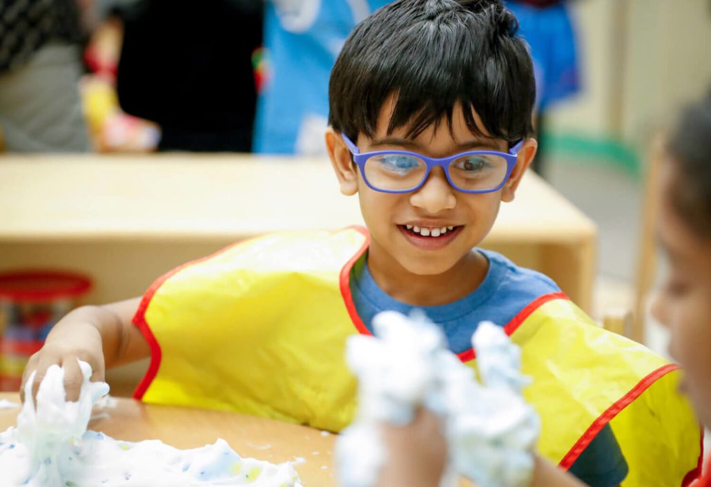 a child smiling indoors