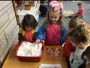 children doing a craft project indoors