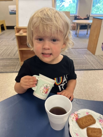 child smiling with drink and snack at fort thomas