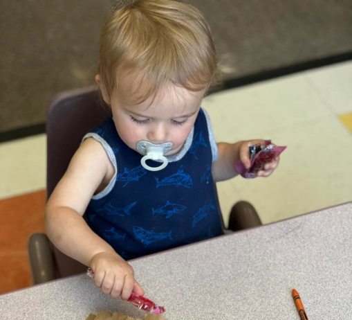 infant playing at cadence academy preschool draper
