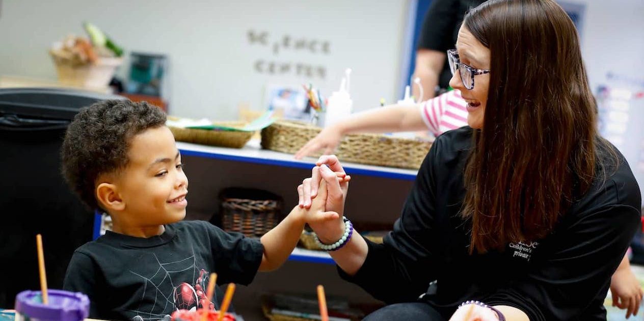 a teacher working with a child
