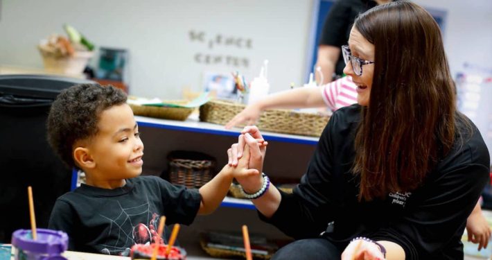 a teacher working with a child