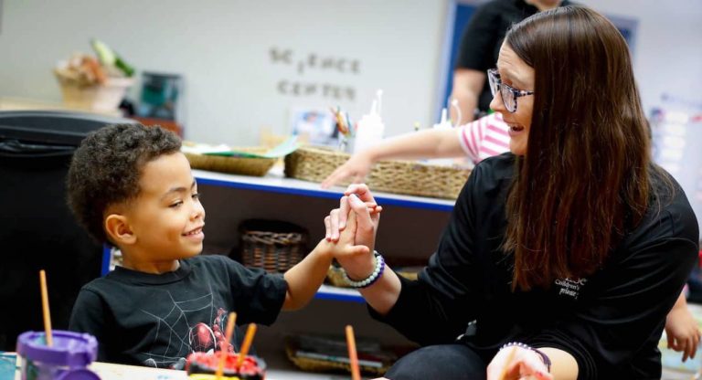 a teacher working with a child