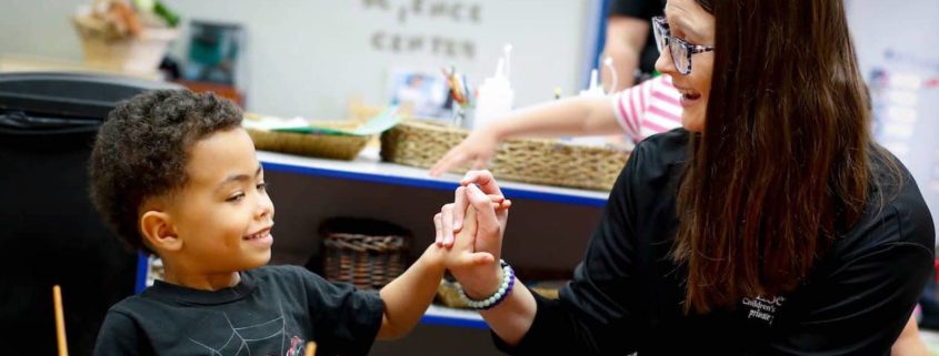 a teacher working with a child