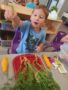 an image of a child holding a carrot