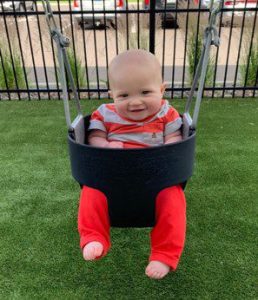 a baby in a swing