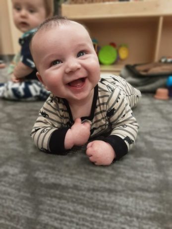 a baby smiling indoors