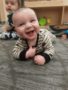 a baby smiling indoors