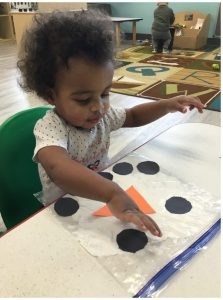 a series of images of a child doing crafts indoors