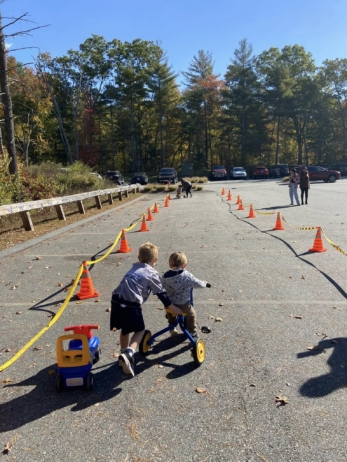 children riding the bike with each other at preschool and daycare at cadence academy preschool 452 south street
