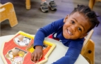 Child smiling with barn animal activity at preschool and daycare at cadence academy preschool 452 south street