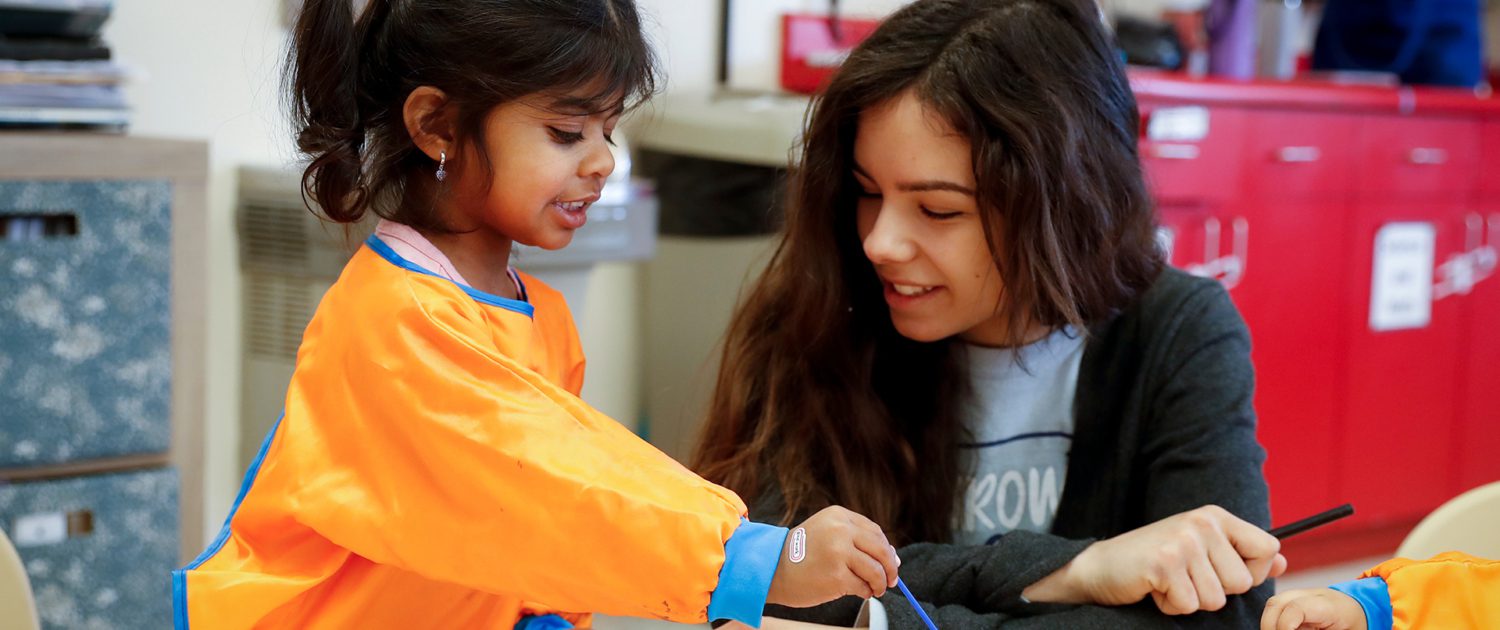 a teacher working with a child