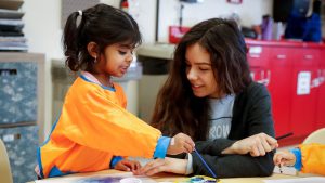 a teacher working with a child