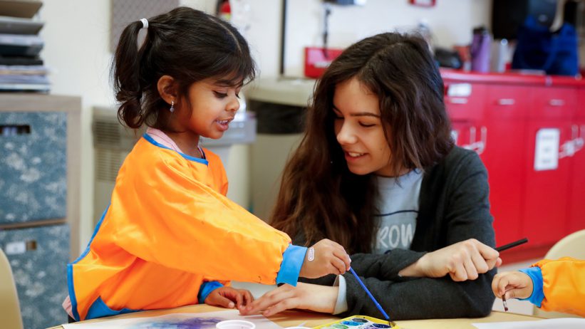 a teacher working with a child