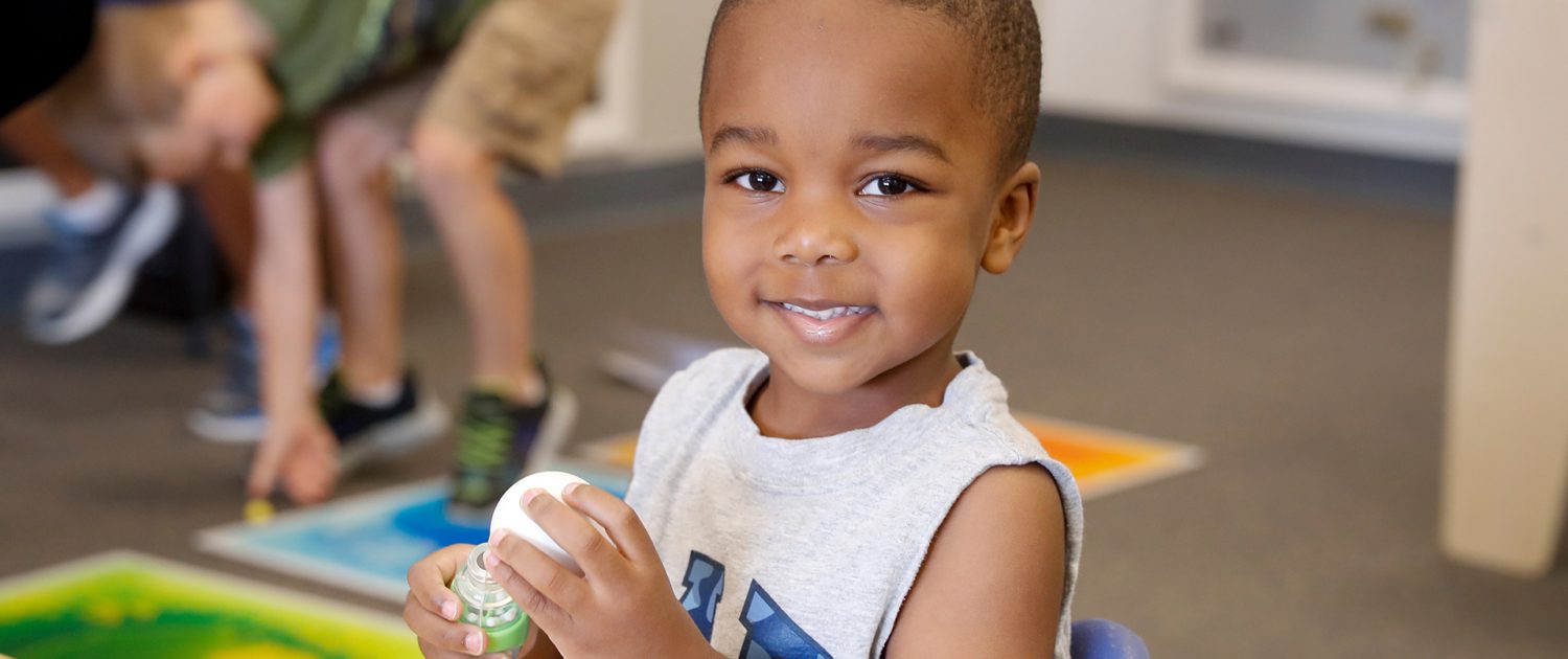 a child smiling indoors