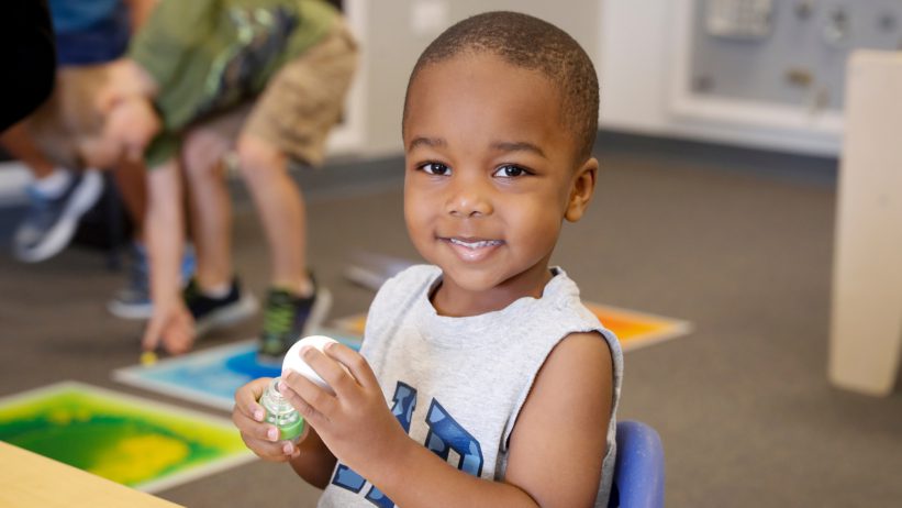 a child smiling indoors