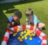 little boys looking at plastic duckies in outside pool
