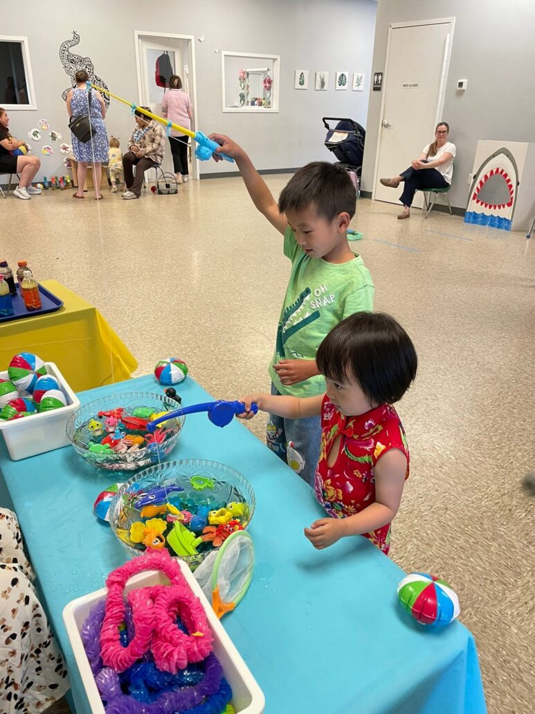 children playing inside at summer activity fishing for toys at cadence academy preschool 453 pond