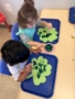 children painting on four leaf clovers at cadence academy preschool 453 pond