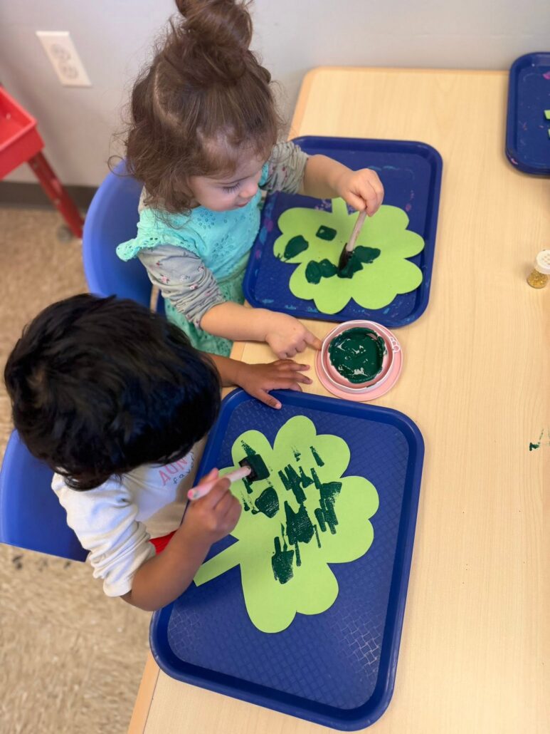 children painting on four leaf clovers at cadence academy preschool 453 pond