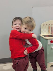 children hugging each other at cadence academy preschool 454 eliot