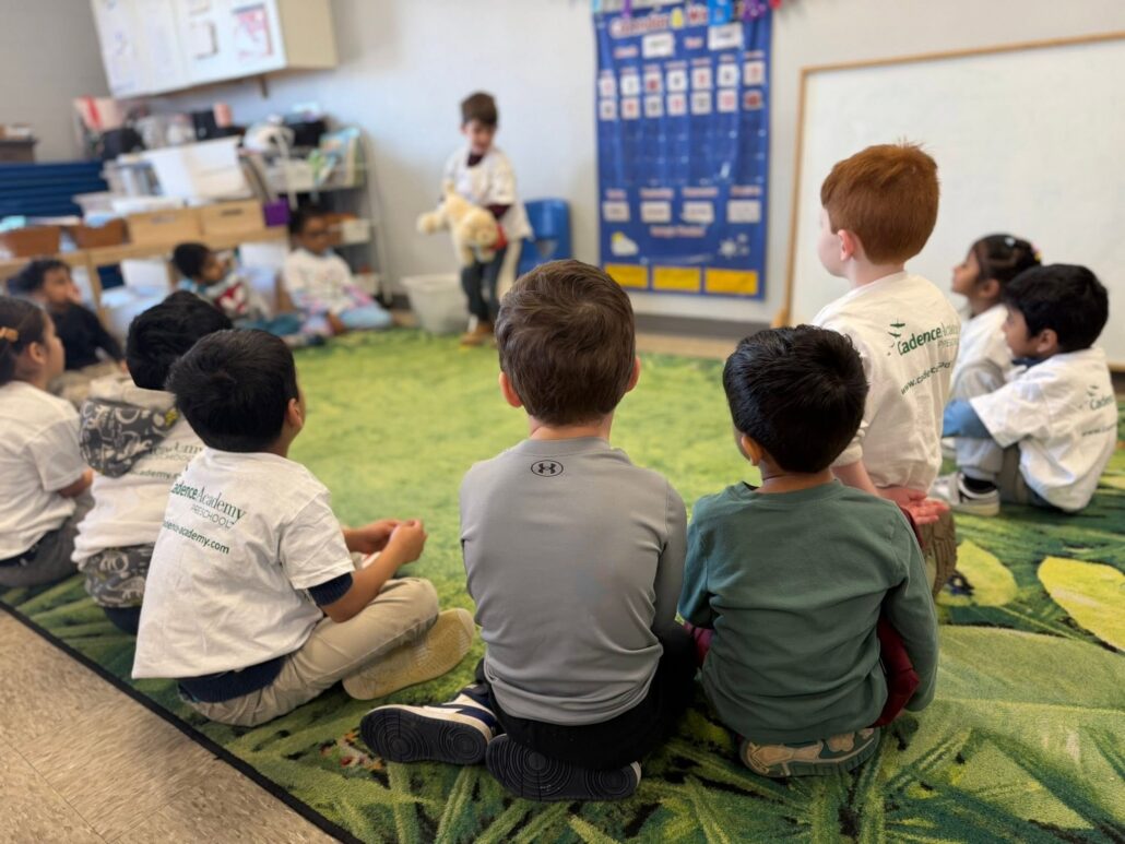 children in circle time doing show and tell on carpet at cadence academy preschool 453 pond