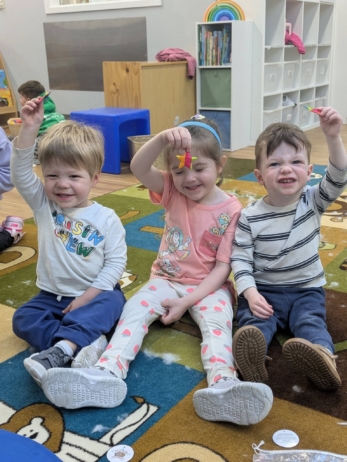children smiling together and showing new toy at cadence academy preschool 454 eliot