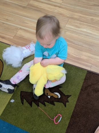 child stuffing stuffed animal at cadence academy preschool 454 eliot