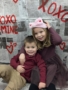 Two children hugging in front of valentines day backdrop at cadence academy preschool 454 eliot
