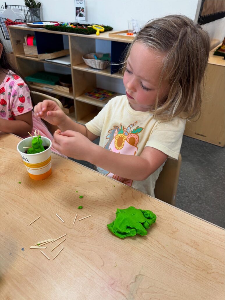 female child engaging in hands on learning at little big minds uptown