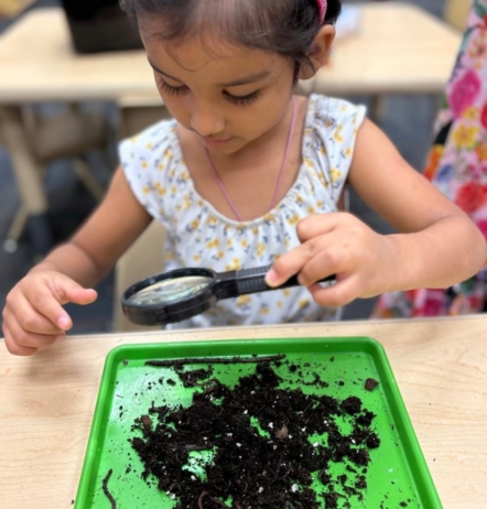 Child learning through hands on activity play at Little Big Minds Kennedy