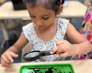 Child learning through hands on activity play at Little Big Minds Kennedy