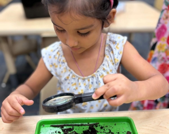 Child learning through hands on activity play at Little Big Minds Kennedy
