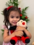 female child hugging stuffed animal ladybug at little big minds uptown