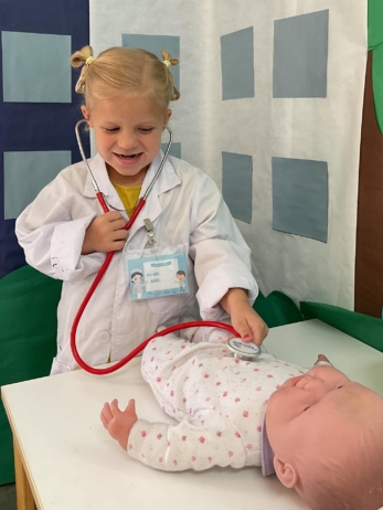 female child playing as doctor learning at little big minds uptown