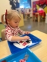 female child working on art craft at little big minds uptown