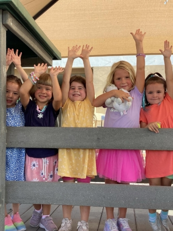female children playing outside at little big minds uptown