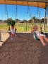 female children playing outside on swings at little big minds uptown