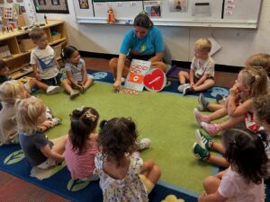 Children learning with assistance from teacher at Little Big Minds Kennedy