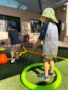 male children playing in water outside little big minds uptown