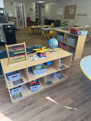 Inside Cadence Academy Preschool small cubbies with learning materials in brightly lit classroom