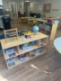 Inside Cadence Academy Preschool small cubbies with learning materials in brightly lit classroom