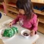 child decorating christmas tree at preschool and daycare at 335 Peter's Colony