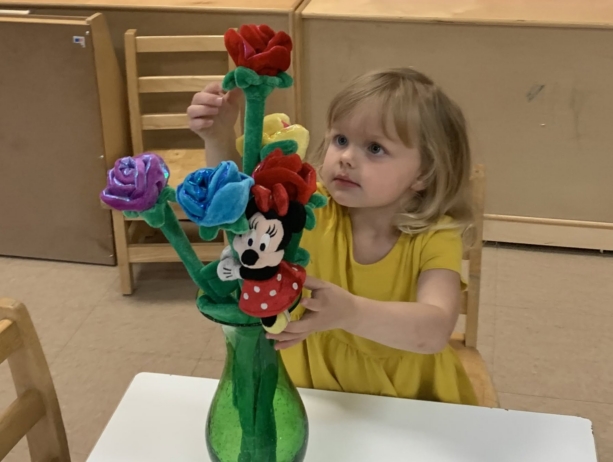 child with flowers at preschool and daycare at 339 Virginia Parkway
